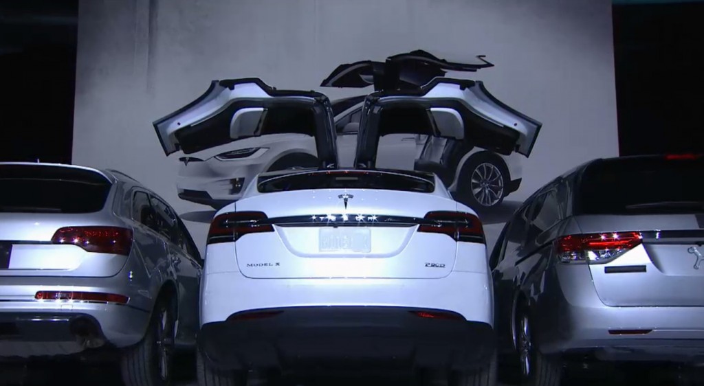 Model X Falcon Wing Doors Open Between Parked Cars