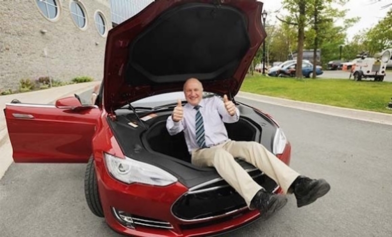 Battery expert Jeff Dahn inside the frunk of a red Model S
