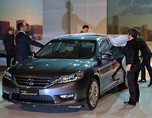Guests unveil a Honda Accord in Jakarta on April 25, 2013. The new model is Honda Prospect Motor