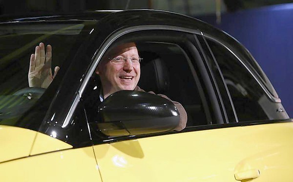General Motors Vice Chairman, interim President of GM Europe and Chairman of the Opel Supervisory Board Girsky waves as he sits inside an Opel Adam car during the start of the car production in Eisenach