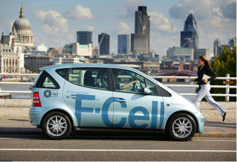 Mercedes-Benz F-Cell hydrogen fuel cell sedan cruises along South Bank of Thames River in London.