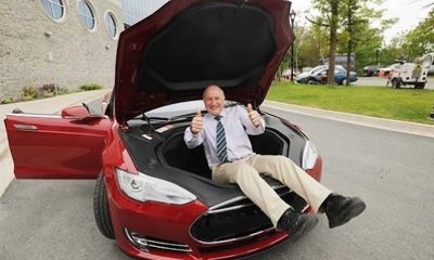 Battery expert Jeff Dahn inside the frunk of a red Model S
