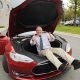 Battery expert Jeff Dahn inside the frunk of a red Model S