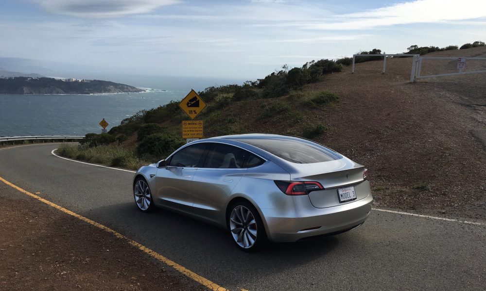 Silver Tesla Model 3 overlooking SF bay