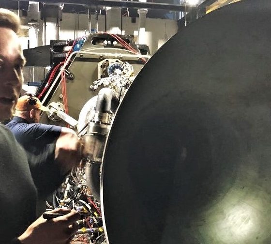 Elon Musk stands beside Raptor's nozzle as SpaceX propulsion prepares for its first hot-fire test. (Elon Musk)