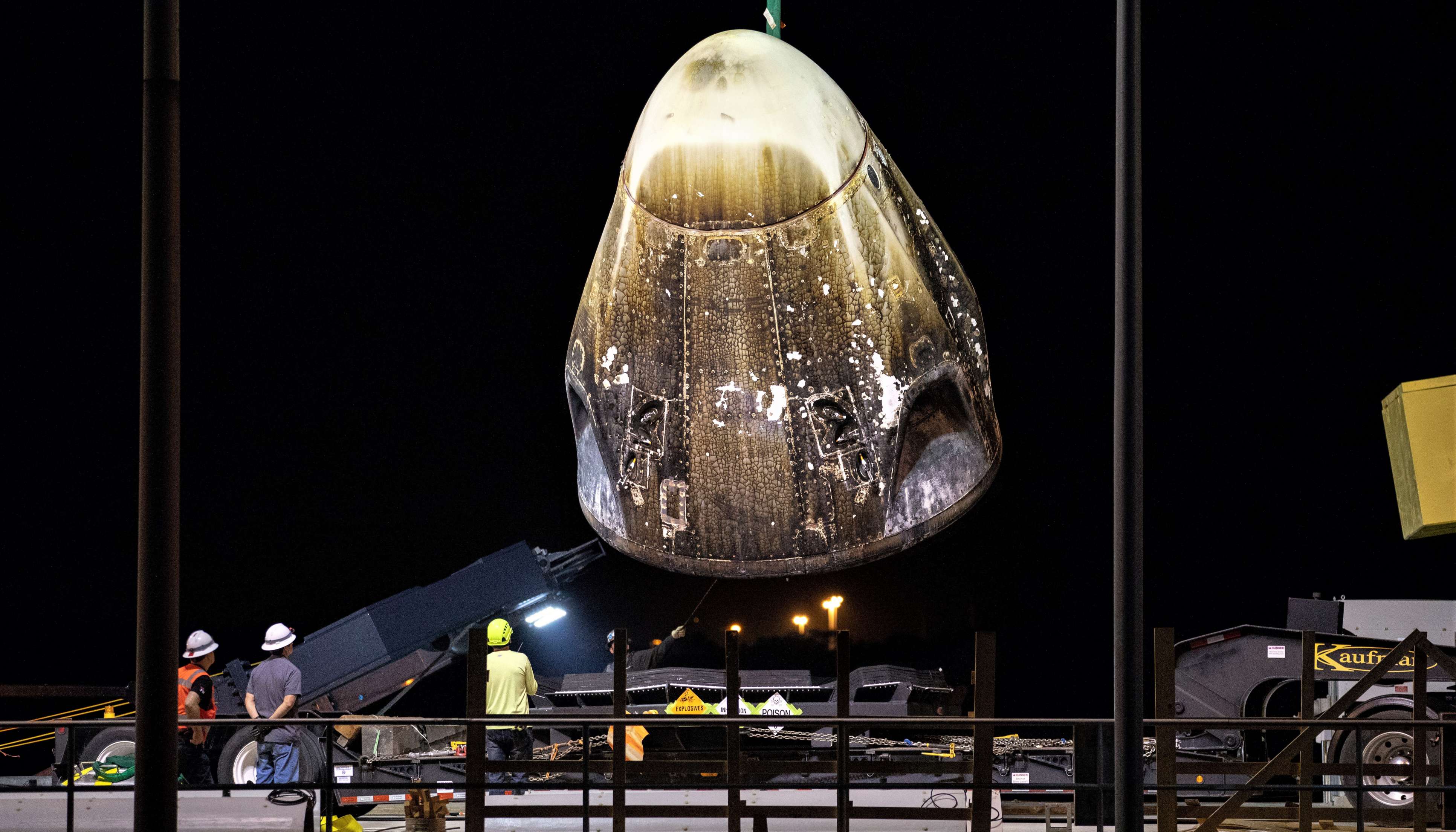 Crew Dragon is lifted off the deck of SpaceX recovery vessel GO Searcher after safely arriving at Port Canaveral, March 10th. (NASA)