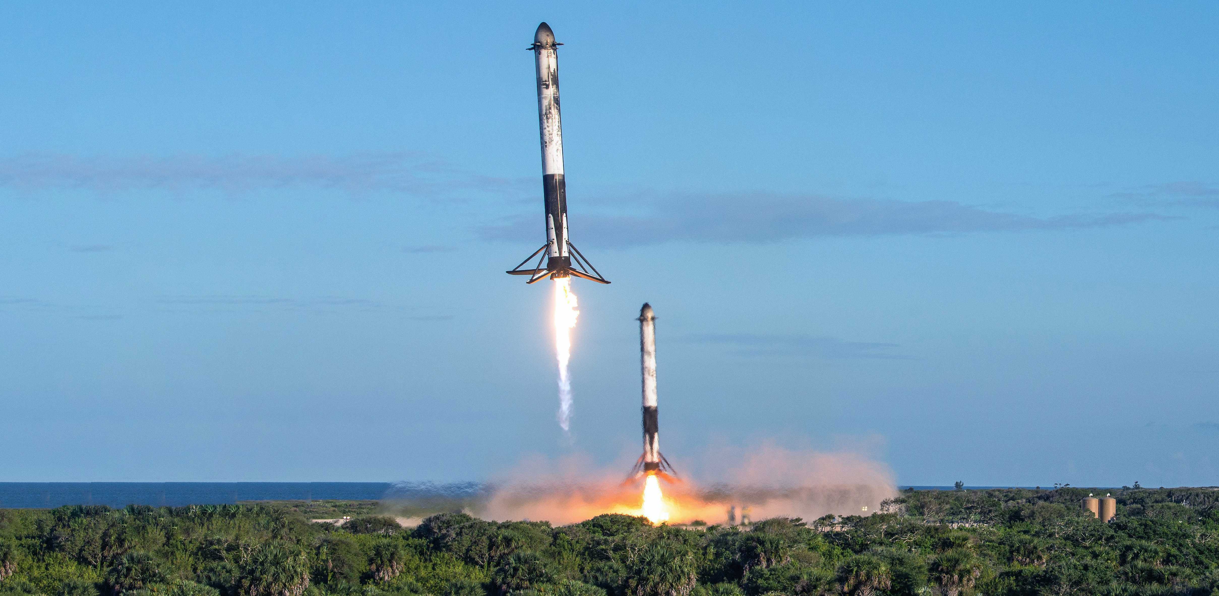 USAF photographer James Rainier's remote camera captured this spectacular view of Falcon Heavy Block 5 side boosters B1052 and B1053 returning to SpaceX Landing Zones 1 and 2. (USAF - James Rainier)