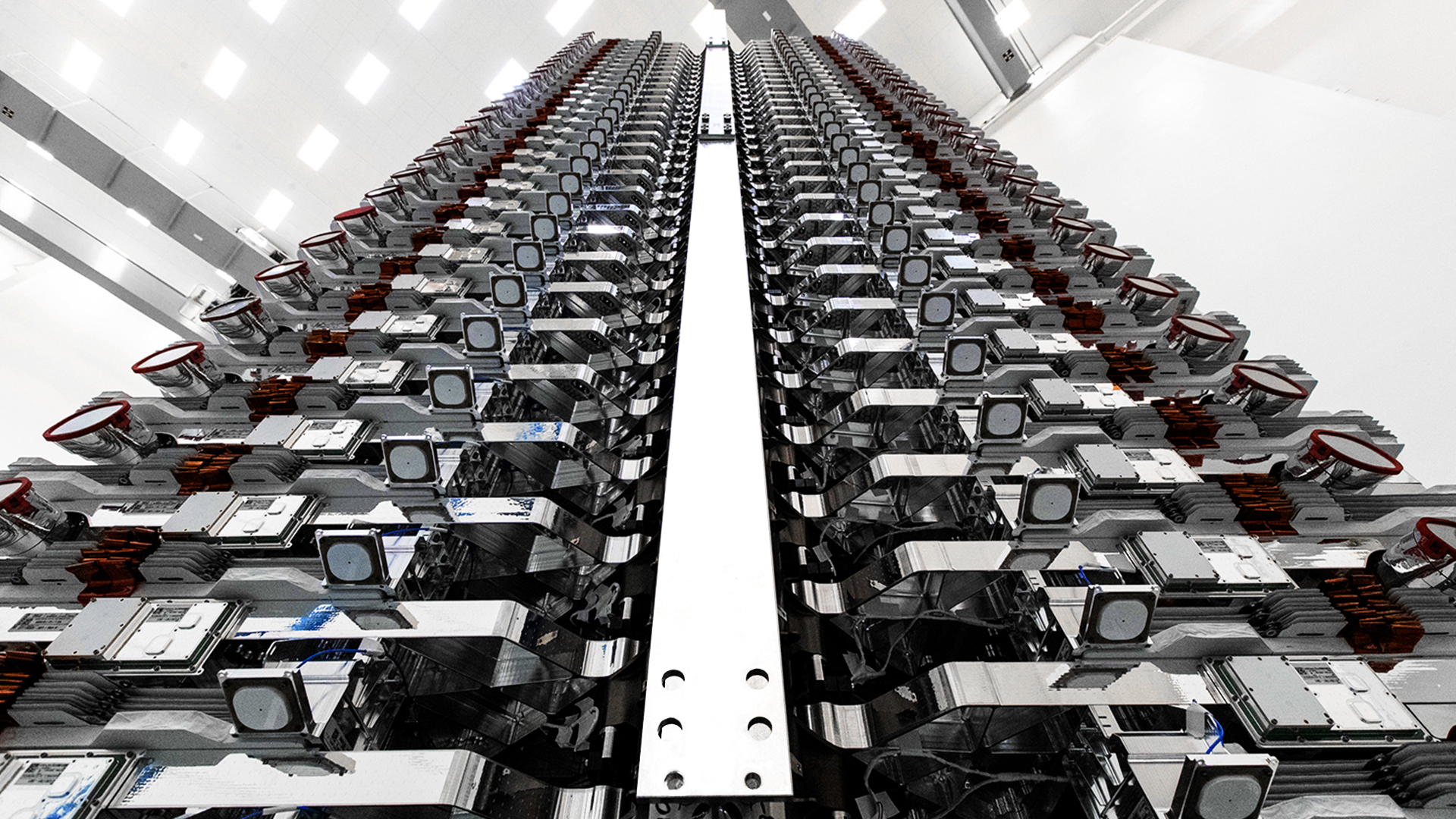 A stack of 60 Starlink v0.9 satellites are prepared for their orbital launch debut in May 2019. (SpaceX)