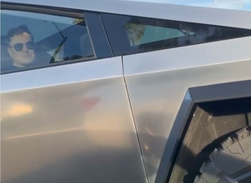 photo of Tesla’s Elon Musk greets passerby in Cybertruck as Jay Leno drives down iconic SpaceX street image