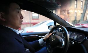 Andrew Yang behind the wheel of a Tesla Model X (Credit: Andrew Yang)