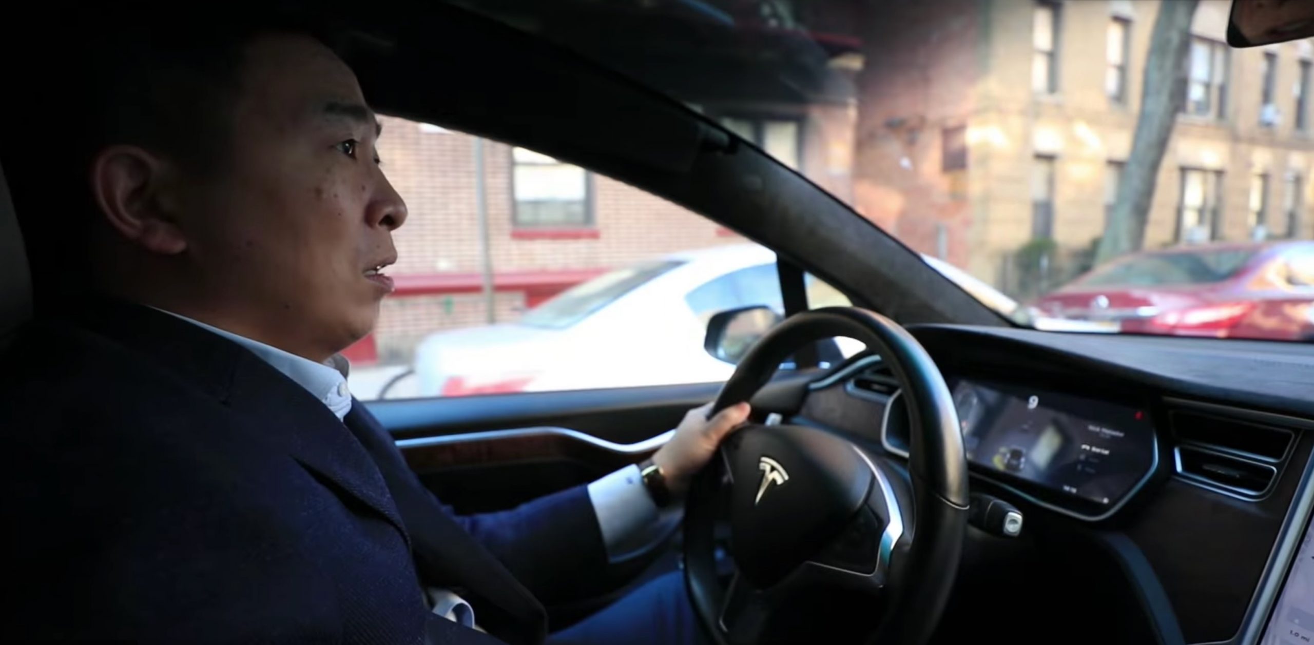 Andrew Yang behind the wheel of a Tesla Model X (Credit: Andrew Yang)