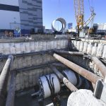 Workers from the Boring Company guide the third of three parts of the drill which will make the tunnel for the People Mover which will connect convention halls as part of the LVCCD Phase 2 construction in the Red Lot east of the south Hall at the Las Vegas Convention center Tuesday, October 29, 2019. (Sam Morris/Las Vegas News Bureau)