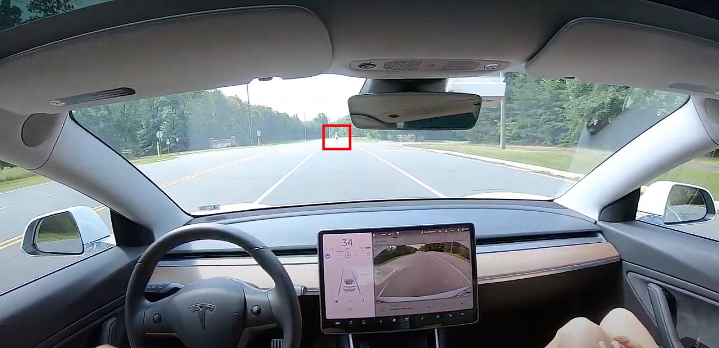 Tesla Autopilot smoothly identifies and slows down for pedestrian in