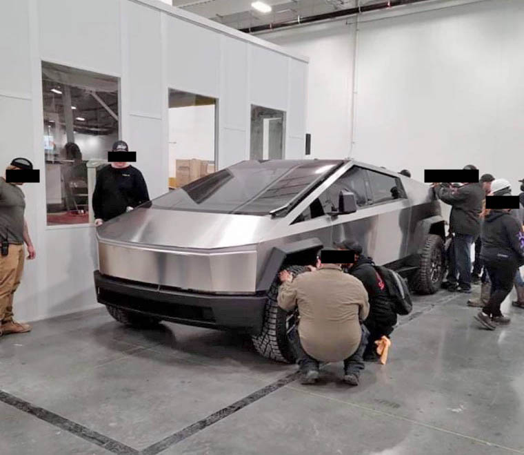 Tesla Cybertruck surrounded by employees 