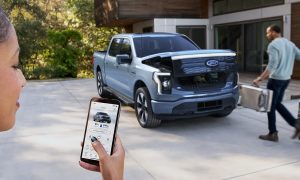 Woman using Phone-as-a-Key feature with Ford F-150 Lightning