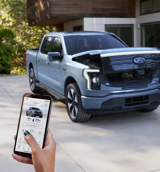 Woman using Phone-as-a-Key feature with Ford F-150 Lightning