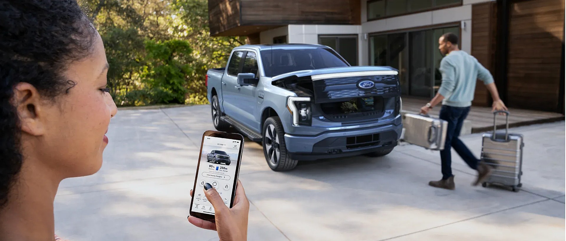Woman using Phone-as-a-Key feature with Ford F-150 Lightning