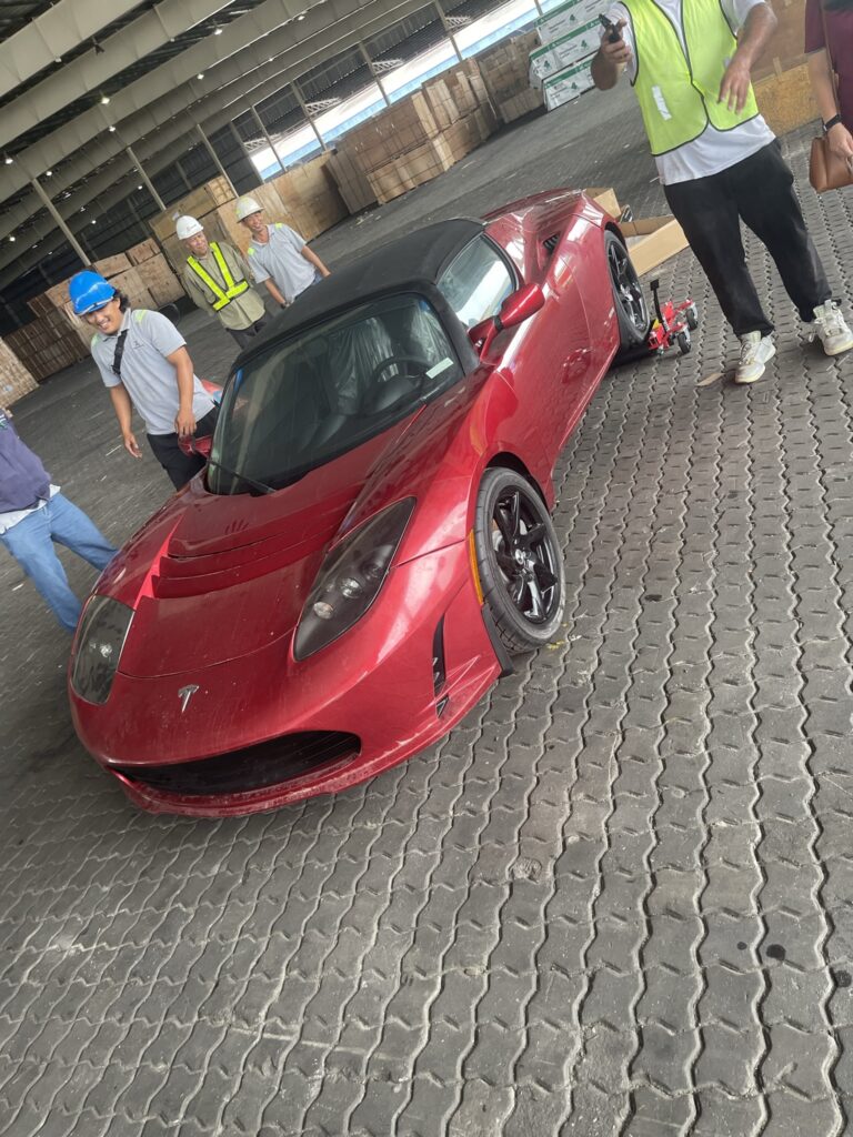 tesla abandoned roadster removed from crate in china