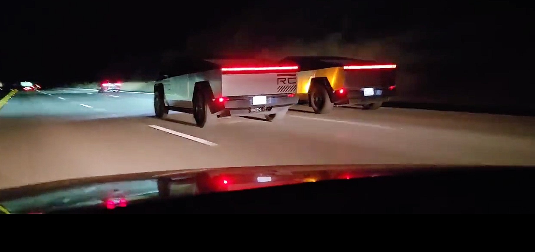 Twin Tesla Cybertrucks cruise down a freeway in coordinated duo