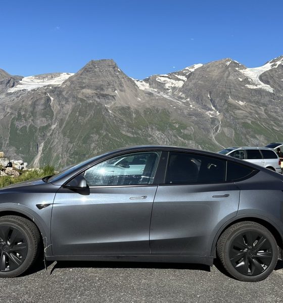 tesla model y in front of mountain range