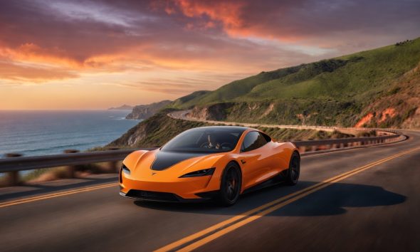 Tesla Roadster driving along sunset cliff (Credit: Grok)