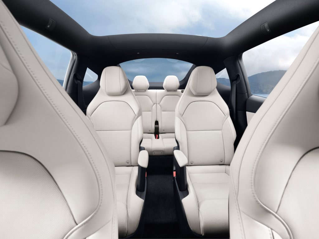 tesla model y l interior looking back showing all six seats