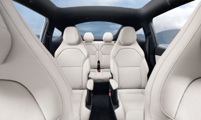 tesla model y l interior looking back showing all six seats