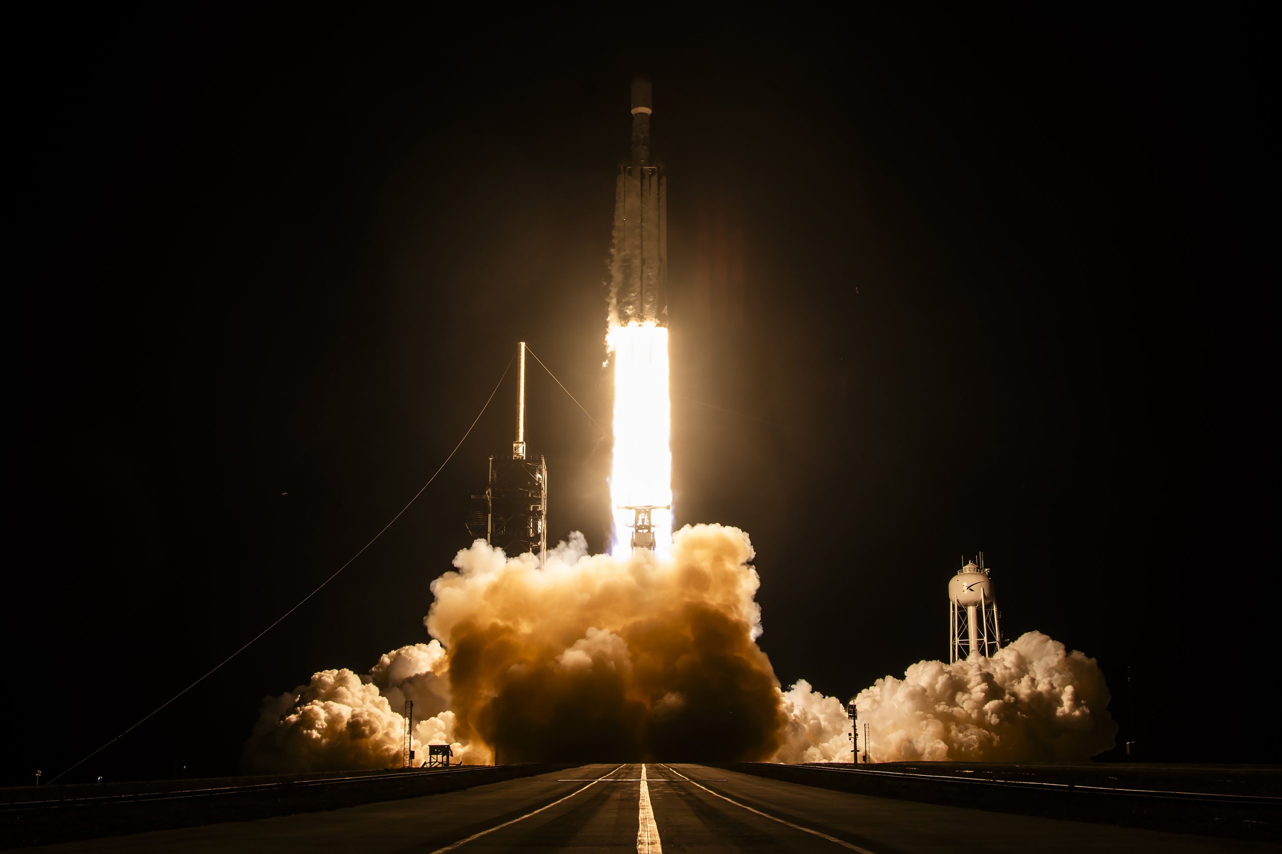 SpaceX's Falcon Heavy lifts off from Launch Complex 39A at NASA's Kennedy Space Center at 11:54 p.m. ET on October 1, 2026, carrying the classified NROL-97 mission for the National Reconnaissance Office. (Credit: SpaceX)