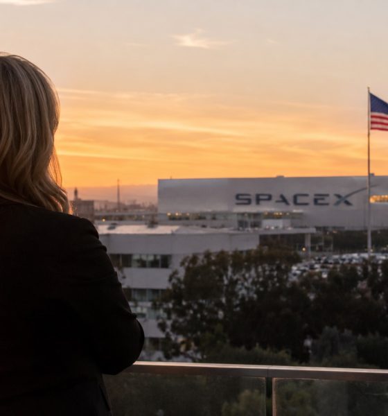 Concept rendering of SpaceX President Gwynne Shotwell overlooks the company’s Hawthorne, California headquarters as an American flag flies over the campus at sunset.