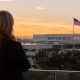Concept rendering of SpaceX President Gwynne Shotwell overlooks the company’s Hawthorne, California headquarters as an American flag flies over the campus at sunset.