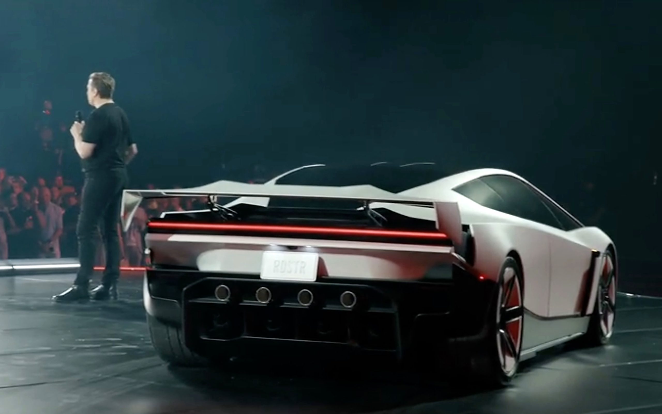 Elon Musk addresses the crowd next to the new Tesla Roadster, which Tesla offers in Performance, Thrust and Rocket versions. (Image: Tesla/X)
