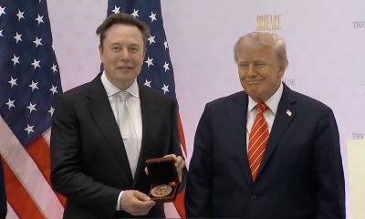 Elon Musk holds the National Medal of Science alongside President Donald Trump at the “Science: A New Golden Age” summit in Washington on October 8, 2026.
